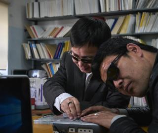 A librarian helps students in Mandalay University's eLibrary room. A librarian helps students in Mandalay University's eLibrary room.