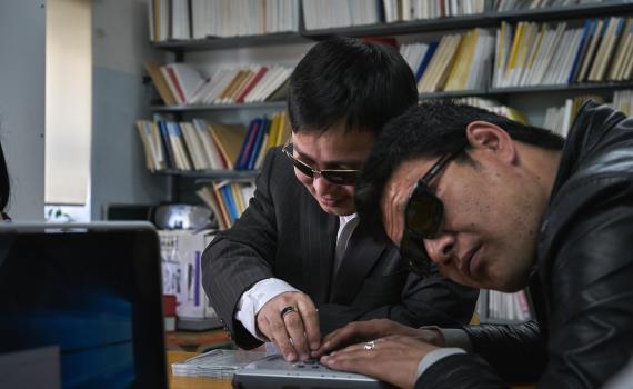A librarian helps students in Mandalay University's eLibrary room. A librarian helps students in Mandalay University's eLibrary room.