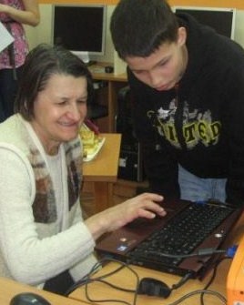 Young volunteers teach seniors to use computers in the library, helping to break down barriers between the generations. Young volunteers teach seniors to use computers in the library, helping to break down barriers between the generations.