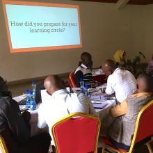 Librarians at a a desk discussing issues related to the project. 