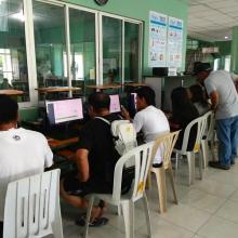 Overseas workers learn how to use computers and to apply online for their Overseas Employment Certificates in Butuan City Library. 