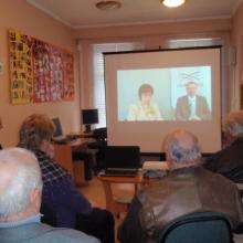 Farmers view a webinar in the library.