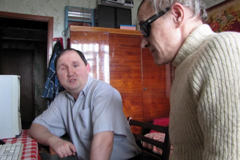 AT HOME: The library’s blind trainer Mr Sergey Rakachov, right, works with trainee Mr Dmitriy Shapovalov at his home.