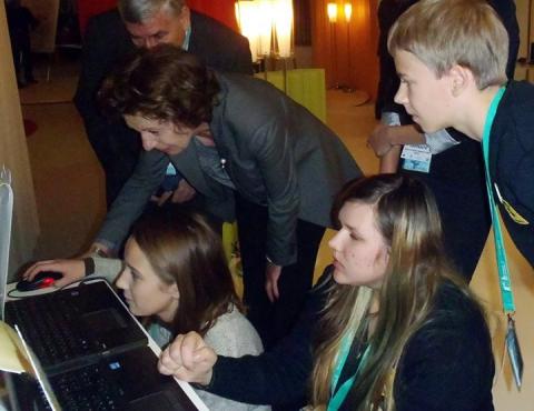 LEARNING TO PLAY: Neelie Kroes, Vice President of the European Union Commission responsible for the Digital Agenda, learns about Utena A.&M. Miskiniai Public Library's innovative educational computer game at ICT 2013 - Europe’s biggest technology conference - in Vilnius, Lithuania. 