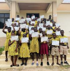 Students at Volta Regional Library holding up their certificates. 