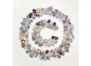 The letter C surrounded by a circle made up of jigsaw pieces.