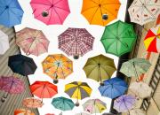 Image from the course - multicoloured umbrellas in the sky, representing data protection.