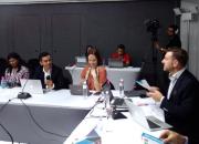 people addressing a panel discussion, at a table