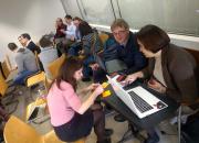 People sitting and working in groups open science trainer bootcamp in Debrecen, Hungary.