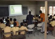 Children learning to use computers in a school classroom in Ghana. 