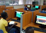 Children looking at computer screen with game