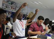 Young African public library innovators using tools during a hands-on experience in the National Library of Lithuania makerspace.