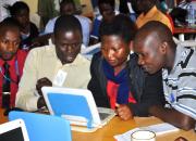 In the photo: three librarians learning computer skills, using a laptop.