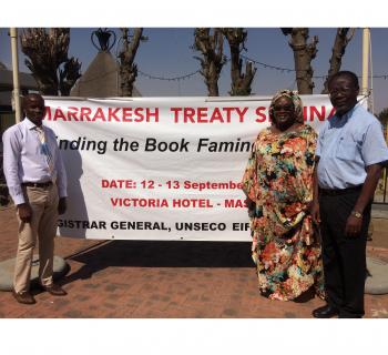 Photo of 3 EIFL copyright librarians (Botswana, Senegal and Kenya) standing in front of a banner on the Marrakesh Treaty seminar in Lesotho in 2017.