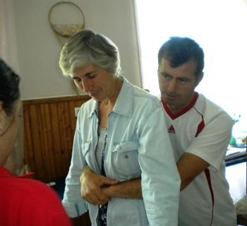 EMERGENCY AID: Library volunteer demonstrates the  Heimlich Maneuver, which saves people from choking.