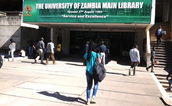 Students walk into the University of Zambia library. 