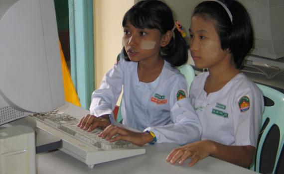 Burmese girls working at a computer.