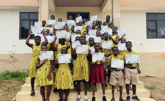 Students at Volta Regional Library holding up their certificates. 