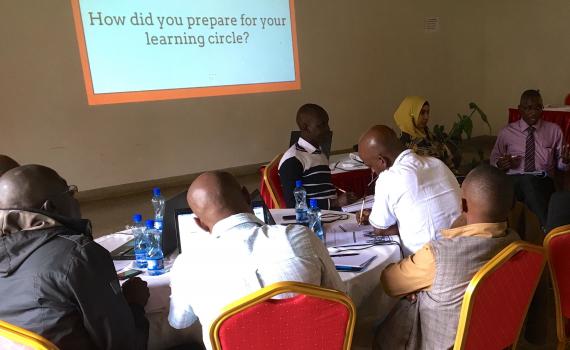 Kenyan librarians reflecting on learnings from the pilot project during the final workshop which took place in Nairobi in July 2017. Librarians at a a desk discussing issues related to the project.