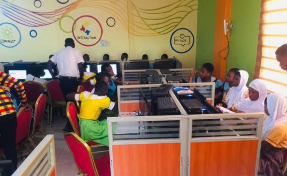 Students using computers in a library in Ghana. 