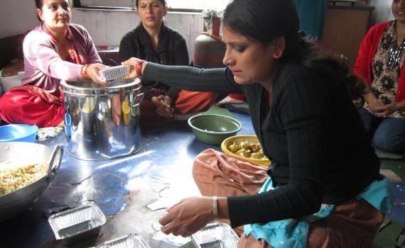 After an intensive 45-day entrepreneurship training course at the library, this group of women teamed up to launch their own business, a lunch box service for banks and offices. A group of women who learnt business skills at the library fill lunch boxes which the sell, as a small business.