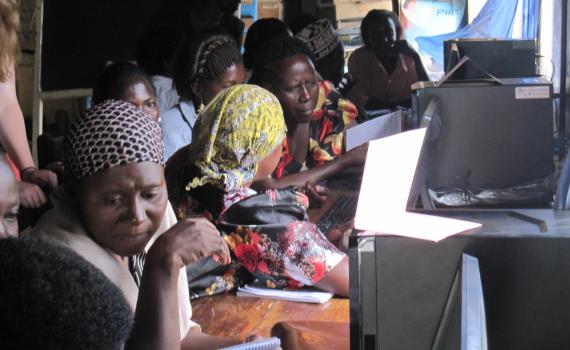 Women farmers learning how to use computers.