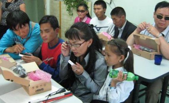 Blind and visually impaired people open boxes with new DAISY readers.