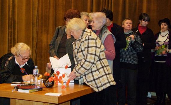 Senior citizens queue up to have their books signed by the famous author.