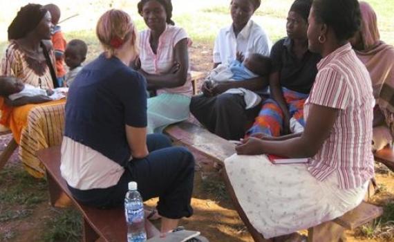 A health workers discussing health issues with a group of women.