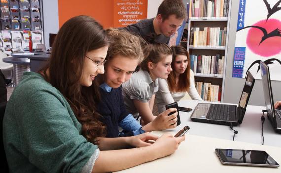 Teenagers using tablet and desktop computers in Piekary Slaskie Municipal Public Library. Photo by Adam Mikosz. Teenagers using tablet and desktop computers in the library. Photo by Adam Mikosz.