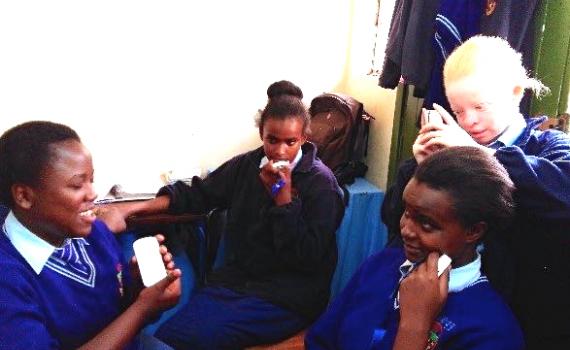 Visually impaired schoolchildren using DAISY (digital audio) devices in Nairobi Area Library. 