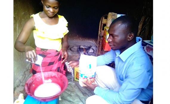Zariakah Kyozira practising new baking skills at home, watched by Isa Maganda, Isa Maganda, Chief Librarian at Nambi Sseppuuya Community Resource Centre in Uganda. Zariakah Kyozira practising new baking skills at home, watched by Isa Maganda, Isa Maganda, Chief Librarian at Nambi Sseppuuya Community Resource Centre in Uganda.